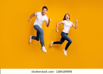 Full length side profile body size photo funky funny she her he him his guy lady jump high hurry shopping black friday low prices wear casual jeans denim white t-shirts isolated yellow background