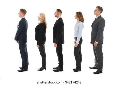 Full Length Side View Of Business People Standing In Row Over White Background