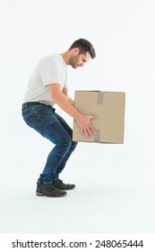 Full Length Side View Of Courier Man Picking Up Cardboard Box On White Background