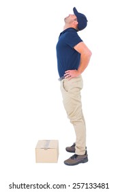 Full length side view of delivery man suffering from back ache on white background
