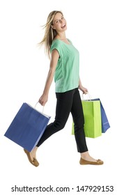 Full Length Side View Of Happy Young Woman Walking With Shopping Bags Isolated Over White Background