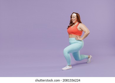 Full length side view happy young chubby overweight plus size big fat fit woman in red top warm up train squating lunges with legs isolated on purple background gym. Workout sport motivation concept
