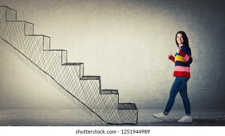 Full length side view portrait young woman showing thumbs up gesture while stepping to stairway  Going up as symbol personal development   successful raising 