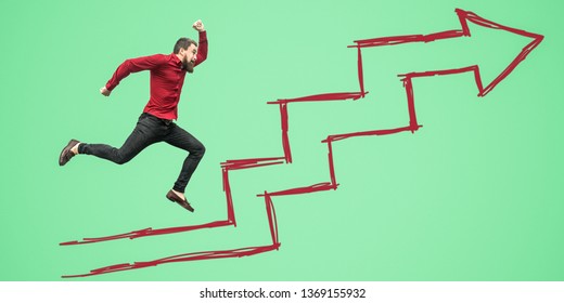Full length side view portrait happy bearded businessman un red shirt jumping flying green background drawed growth steps arrow  success  motivation   result concept  indoor studio shot 