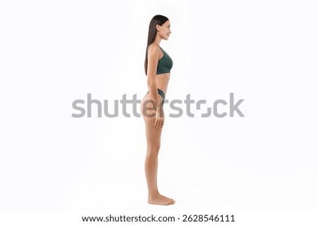 Full length side view of slim woman in underwear posing isolated on white background, copy space