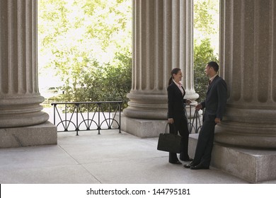 Full Length Side View Of Two Attorneys Talking At Courthouse