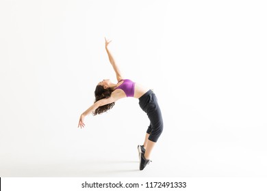 Full Length Side View Of Young Jazz Dancer On Tiptoes Bending Backward On White Background