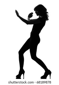 Full Length Silhouette In Shadow Of A Young Woman Fight Karate  Self Defense  In Studio On White Background Isolated