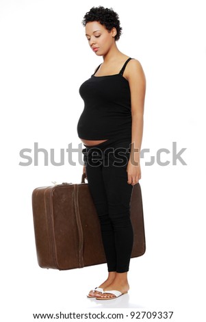 Full length site view of a sad pregnant woman holding a case.