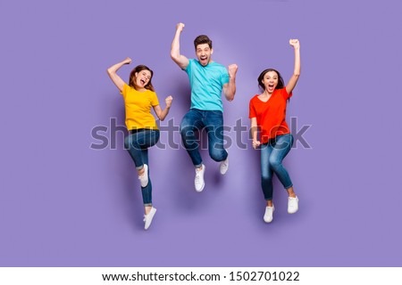 Full length size body photo of three crazy funky carefree buddies teamwork company raising fists up isolated violet background