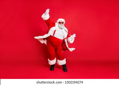 Full Length Size Photo Of Carefree Delightful Rejoicing Funky Holly-jolly Moving St Nicholas Father Christmas Big Belly In Suspenders Traditional Outfit Fur Trousers Sunglass Boots Isolated Background