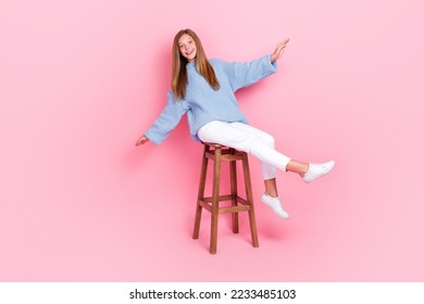 Full length size of smiling teenager school lady wear stylish outfit sitting bar chair rising hands up good mood isolated on pink color background - Shutterstock ID 2233485103