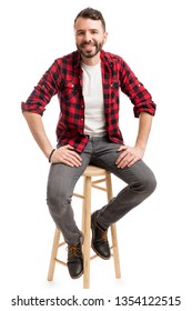 Full Length Of Smart Man Sitting On Stool Against Plain Background