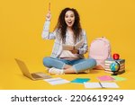 Full length smart young black teen girl student she wear casual clothes backpack bag sit read book pont index finger up isolated on plain yellow color background High school university college concept