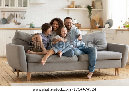 Full length smiling father holding cellphone, making selfie shot, recording video with happy wife and little kids siblings. Excited parents looking at mobile screen with kids, feeling excited. Foto stock © 
