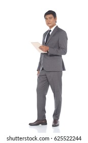 Full Length Snap Figure, Tablet Gold In Hand, Business Man Stand In Dark Gray Suit Pants And Brown Shoes, Studio Lighting White Background Isolated