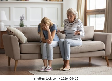 Full Length Stressed Millennial Blonde Woman Ignoring Angry Senior Old Mother, Lecturing Her At Home. Young Grown Up Daughter Tired Of Toxic Relationship With Aggressive Mom, Generations Gap.