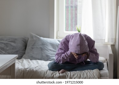 Full Length Stressed Young Teenage Child Girl Sitting On Bed, Covering Head With Hands, Suffering From Loneliness Or School Bullying. Unhappy Adolescent Kid Daughter Feeling Depressed Alone At Home.