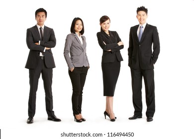 Full Length Studio Portrait Of Chinese Business Team