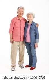 Full Length Studio Shot Of Chinese Senior Couple