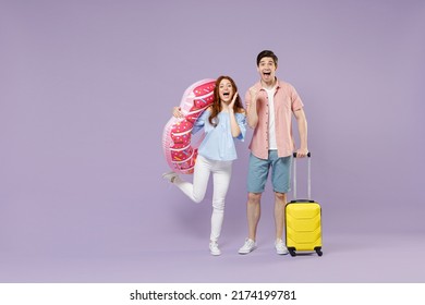 Full length two amazed traveler tourist woman man couple wears shirt suitcase inflatable ring hold face isolated on purple background Passenger travel abroad weekend getaway Air flight journey concept - Powered by Shutterstock