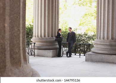 Full Length Of Two Attorneys Talking Outside Courthouse