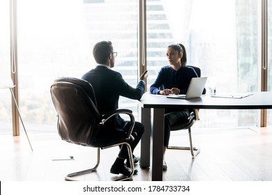 Full Length Two Focused Successful Business People In Formal Wear Discussing Enterprise Development Strategy, Negotiating Project Details, Analyzing Financial Strategy Or Having Serious Talk In