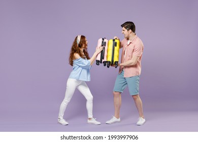 Full Length Two Traveler Tourist Woman Man Couple In Shirt Holding Suitcase Fight Fooling Around Isolated On Purple Background. Passenger Travel Abroad On Weekends Getaway. Air Flight Journey Concept