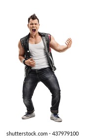 Full length vertical shot of a young punk rocker playing an air guitar isolated on white background