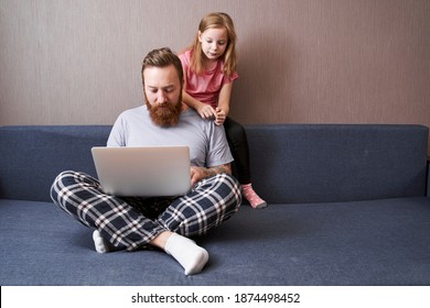 Full Length View Of The Bearded Handsome Man Working With His Laptop Computer While His Blonde Pretty Girl Looking Over His Shoulder At The Screen