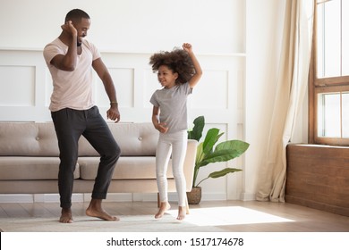 Full Length View In Cozy Warm Sunny Living Room African Handsome Father Dancing With Little Adorable Daughter, Family Spending Time On Weekend Together, Enjoy Life Listening Favourite Music Concept