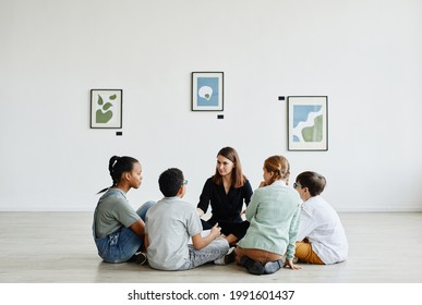 Full Length View At Diverse Group Of Children Sitting In Circle During Class In Art Gallery, Copy Space