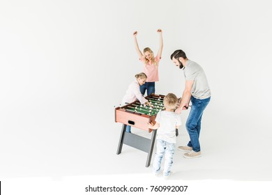 Full Length View Of Family Playing Table Football Isolated On White