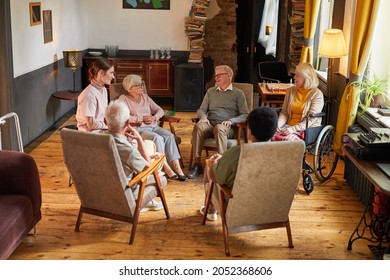 Full length view at group of senior people sitting in circle during therapy session at retirement home, focus on woman crying, copy space - Powered by Shutterstock