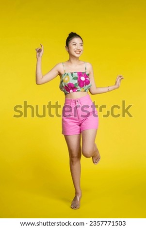 Full length view of joyful woman standing on one leg.