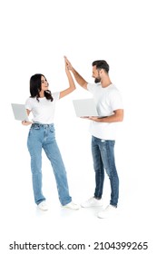 Full Length View Of Pleased Couple With Laptops Looking At Each Other And Giving High Five On White