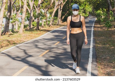 Full Length Of Woman In Medical Mask Exercise Walking In The Park