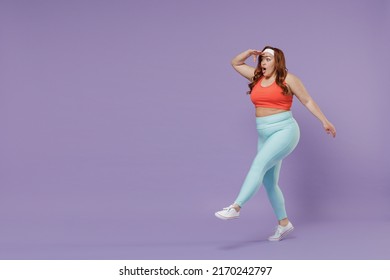 Full length young chubby overweight plus size big fat fit woman in top warm up training hold hand forehead look far away distance go isolated on purple background gym. Workout sport motivation concept