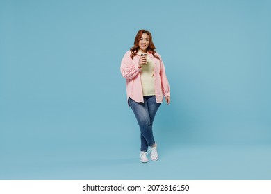 Full Length Young Happy Redhead Chubby Overweight Woman 30s Wear Pink Shirt Casual Clothes Hhold Takeaway Delivery Craft Paper Brown Cup Coffee To Go Isolated On Pastel Blue Background Studio Portrait