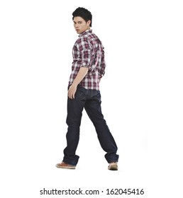 Full length Young man in jeans standing back on white background