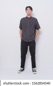  Full Length Young Man In Wearing Black Short Sleeve Shirt With Black Jeans And Sneakers Shoes Posing 
