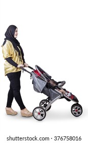 Full Length Of A Young Muslim Mother Pushing A Baby Stroller, Isolated On White Background