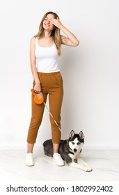 A Full Length Young Pretty Woman With Her Dog Covering Eyes By Hands