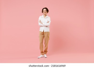 Full length young smiling happy cheerful successful employee business woman corporate lawyer in classic formal white shirt work in office hold hands crossed isolated on pastel pink background studio. - Shutterstock ID 2181616969