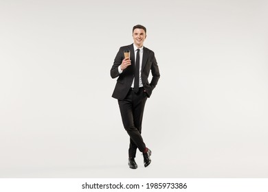 Full Length Young Successful Rich Employee Business Corporate Lawyer Man In Classic Formal Black Grey Suit Shirt Tie Work In Office Hold Paper Cup Coffee Drink Tea Isolated On White Background Studio