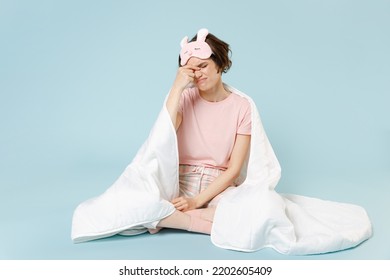 Full Length Young Woman In Pajamas Jam Sleep Eye Mask Rest At Home Sit Wrap Cover Blanket Duvet Keep Eyes Closed Rub Put Hand On Nose Isolated On Pastel Blue Background Bad Mood Night Bedtime Concept