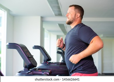 full male runs on a treadmill in a gym. concept of weight loss and sport. side view - Shutterstock ID 1456626641
