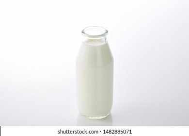 Full Of Milk In The Glass Bottle With Lid Open