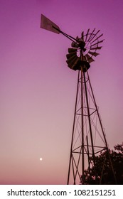 A Full Mon Shines Over A Windmill.