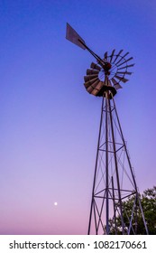 A Full Mon Shines Over A Windmill.